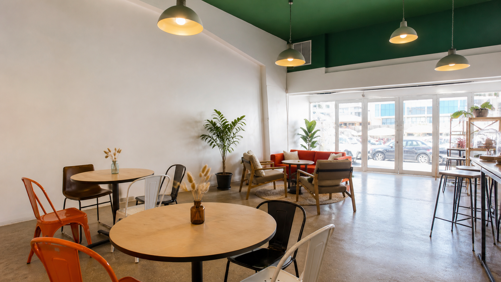 Interior of Sweet Side of Thingz with a forest-green ceiling, pendant lights, mixed seating and storefront windows